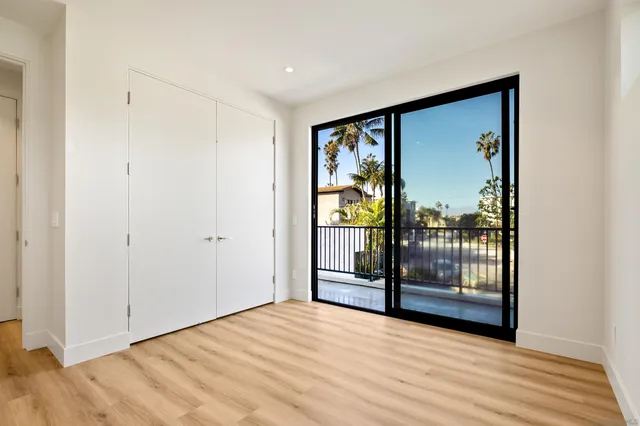 a view of an empty room with glass door