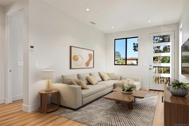 a living room with furniture or couch and a potted plant