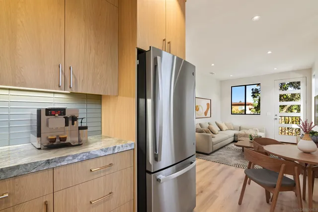 a kitchen with stainless steel appliances granite countertop a refrigerator and a sink