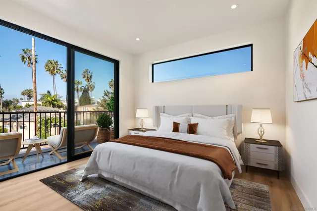 a bedroom with a large bed and a painting on the wall