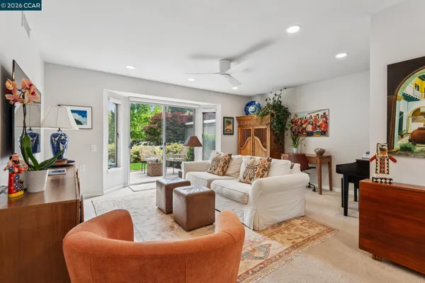a living room with fireplace furniture and a large window
