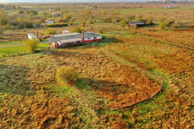 an aerial view of residential houses with outdoor space