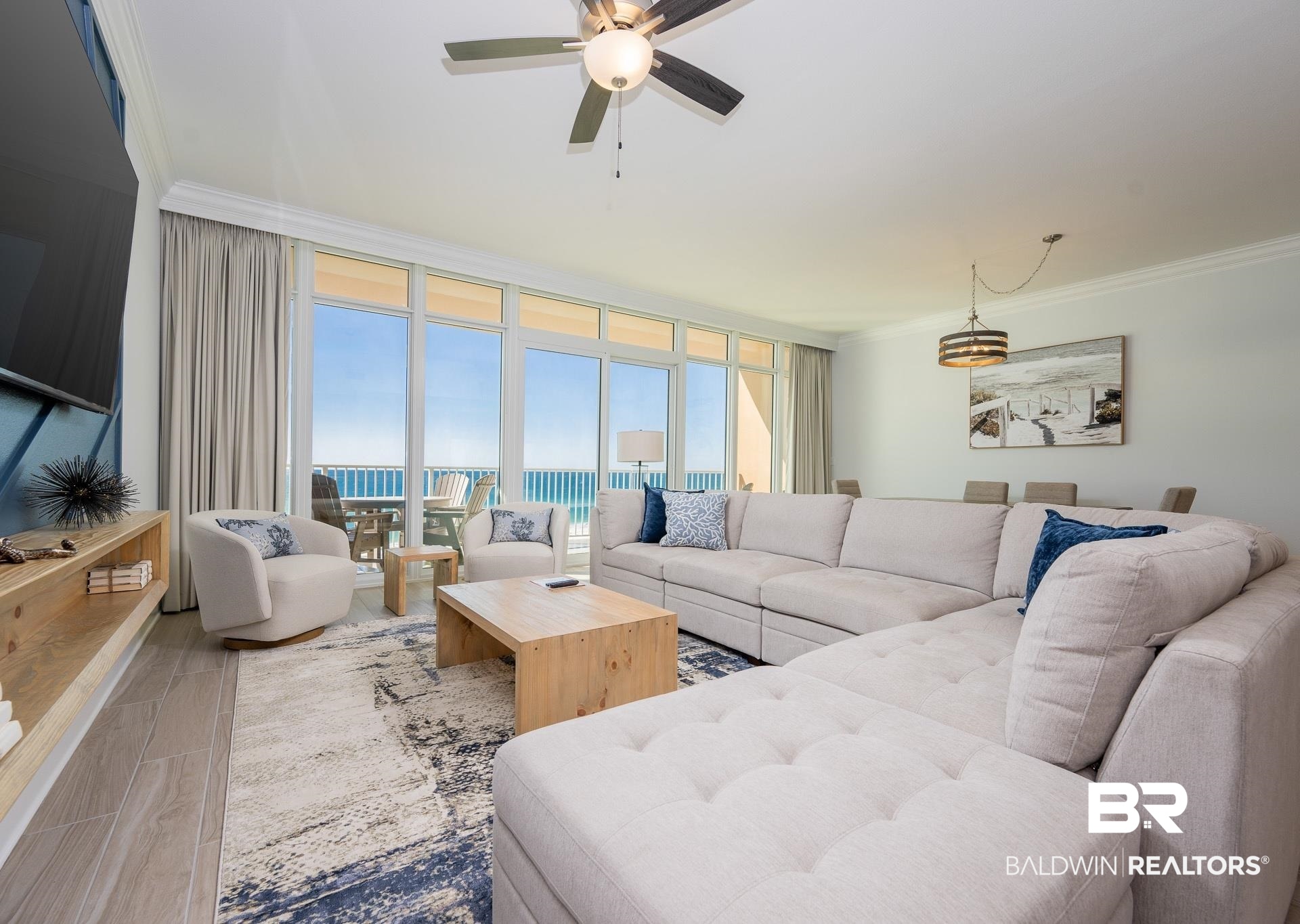 23008 Perdido Beach Boulevard, Unit 506 Orange Beach, AL 36561 - Photo 7 of 48 Living room with ornamental molding, ceiling fan, and wood finished floors