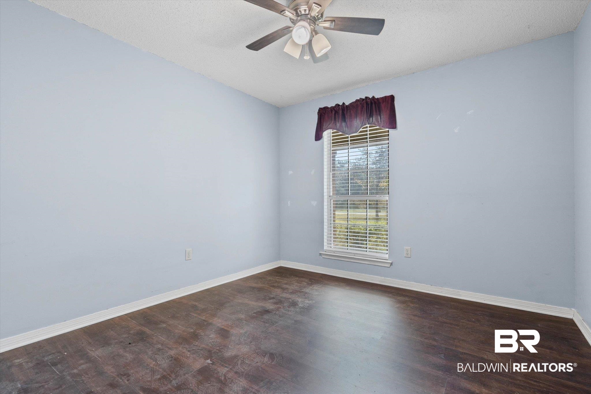 180 Creax Road Axis, AL 36505 - Photo 17 of 35 Unfurnished room featuring dark wood-style floors, a textured ceiling, and ceiling fan