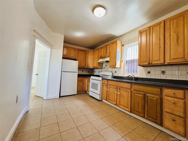 a kitchen with stainless steel appliances granite countertop a refrigerator sink and cabinets