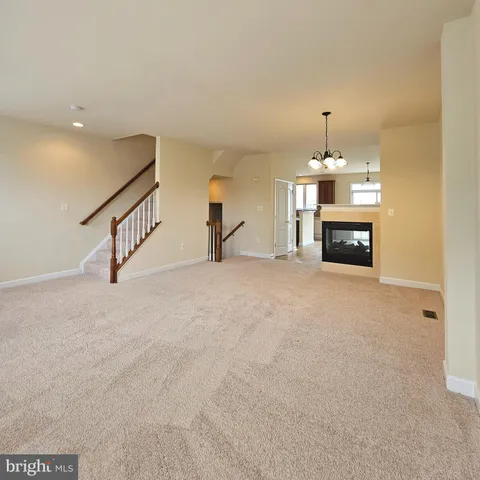 a view of a livingroom with fireplace and window