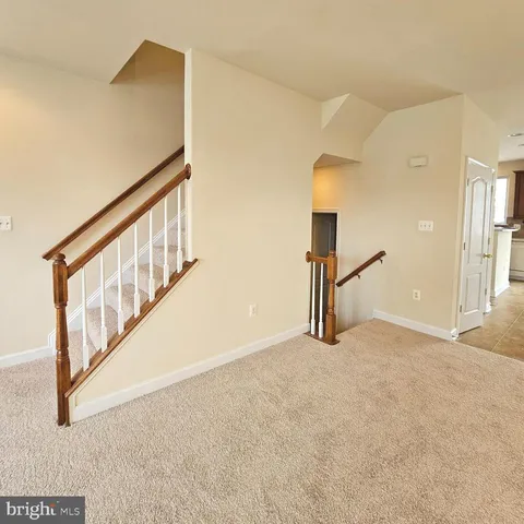 a view of an empty room with stairs