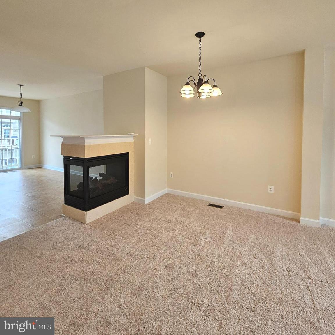 725 Chevington Court Woodbridge, VA 22191 - Photo 14 of 36 a view of an empty room with a fireplace and window