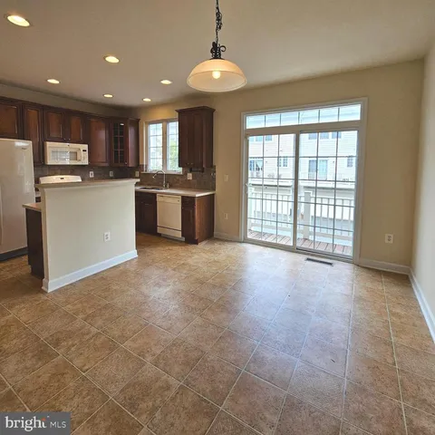 a view of kitchen with stainless steel appliances granite countertop a stove top oven a sink a counter space and cabinets