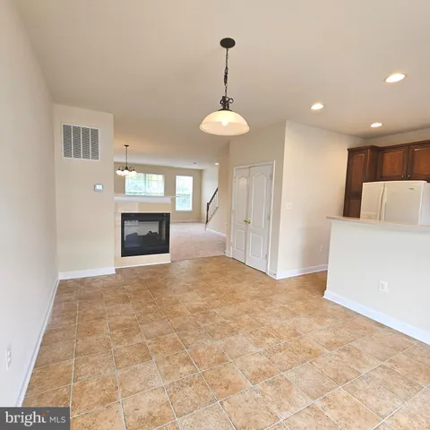 a kitchen with stainless steel appliances granite countertop a stove top oven a refrigerator and a sink