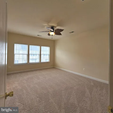 an empty room with windows and cabinet