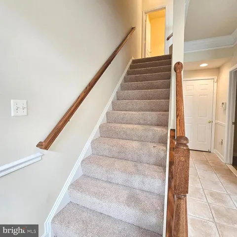 a view of staircase with white walls and windows
