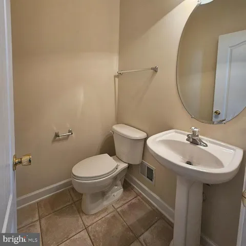 a bathroom with a sink toilet and a mirror