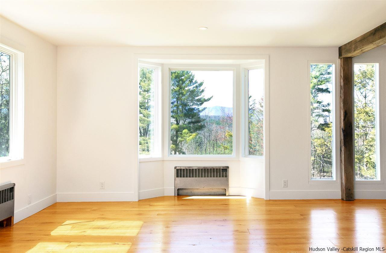 4701 Atwood Road, Unit ROUTE 213 Stone Ridge, NY 12484 - Photo 2 of 35 a view of an empty room with wooden floor and a window