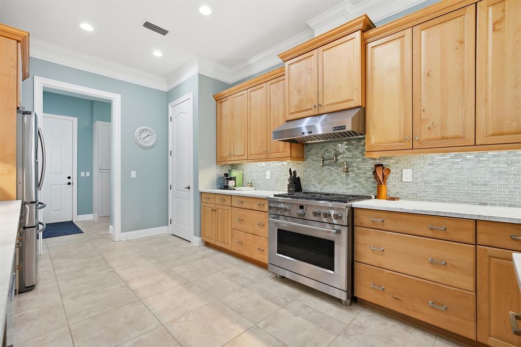 6595 Collier Road St. Augustine, FL 32092 - Photo 20 of 98 a kitchen with stainless steel appliances granite countertop a stove a sink and a refrigerator with cabinets