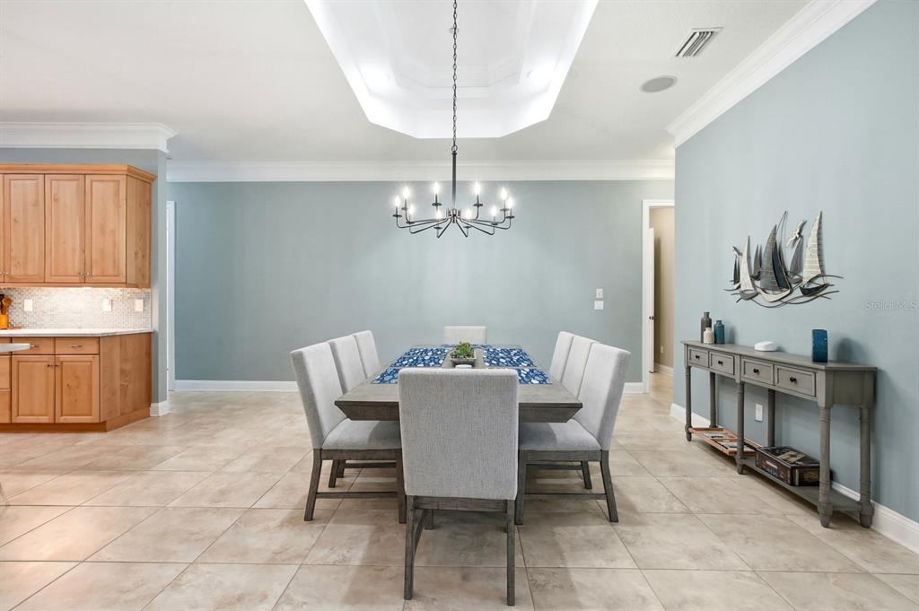 6595 Collier Road St. Augustine, FL 32092 - Photo 24 of 98 a dining room with furniture a chandelier and window