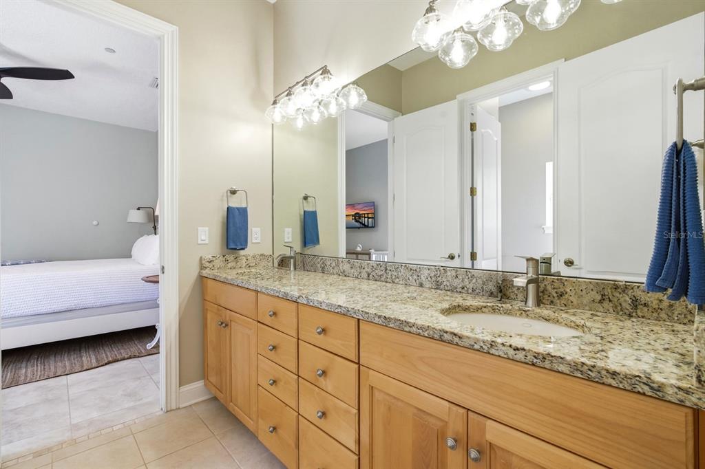 6595 Collier Road St. Augustine, FL 32092 - Photo 36 of 98 a bathroom with a granite countertop double vanity sink a vanity and a large mirror