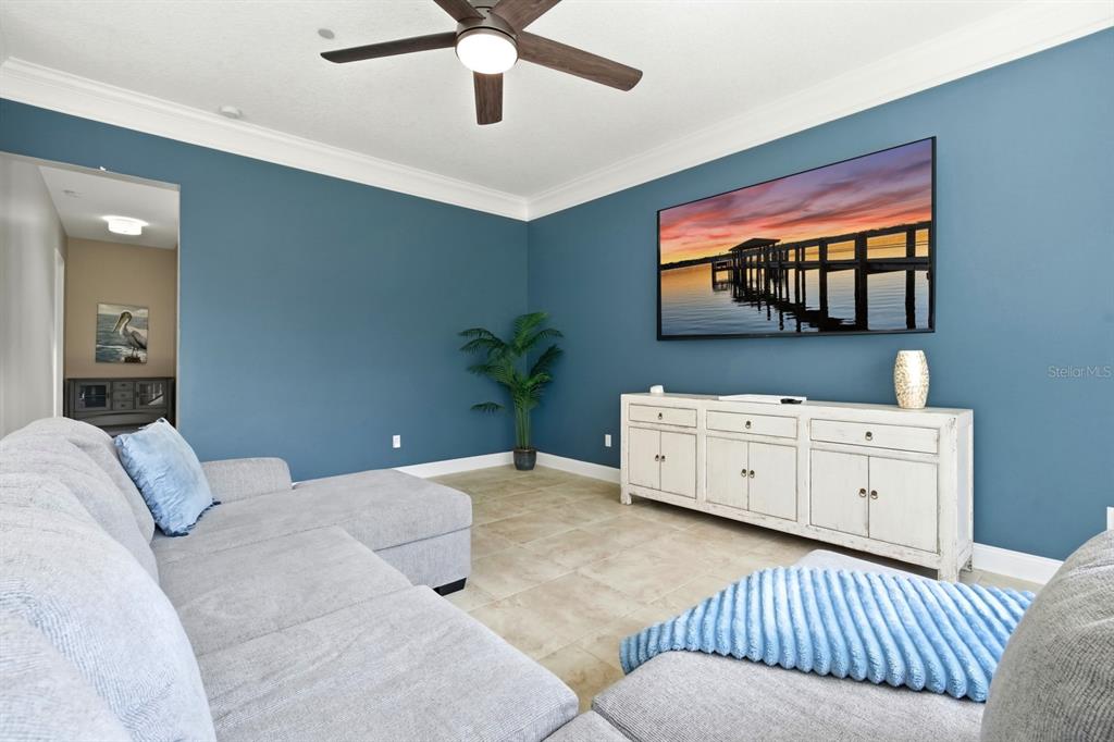 6595 Collier Road St. Augustine, FL 32092 - Photo 47 of 98 a bedroom with a large bed and a flat tv screen on dresser