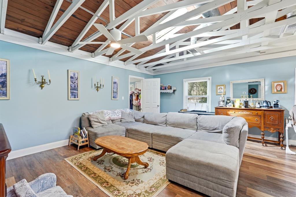 6595 Collier Road St. Augustine, FL 32092 - Photo 91 of 98 a living room with furniture a table and wooden floor