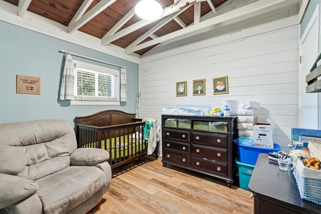 6595 Collier Road St. Augustine, FL 32092 - Photo 95 of 98 a bedroom with furniture and wooden floor