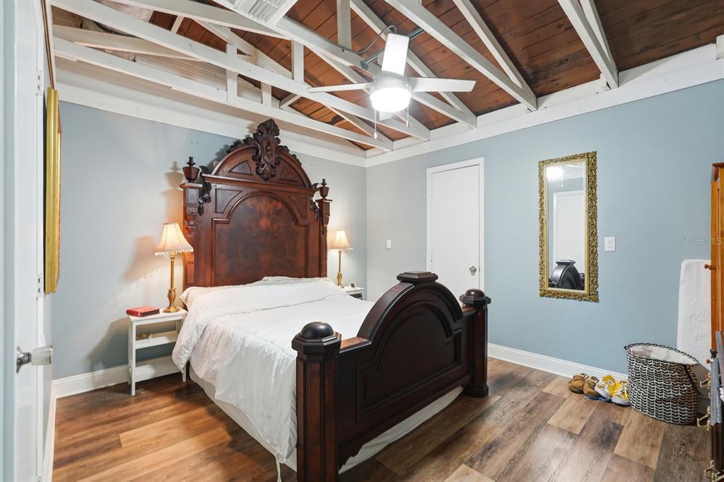 6595 Collier Road St. Augustine, FL 32092 - Photo 97 of 98 a bedroom with a bed and wooden floor