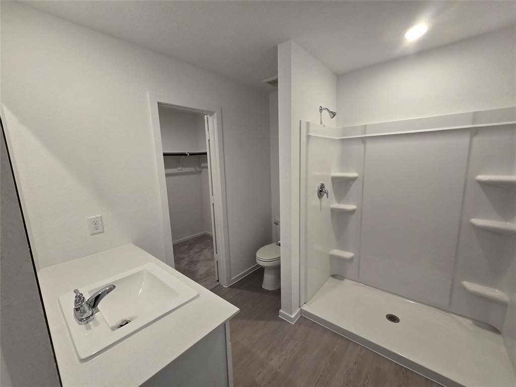 658 Maria Elena Way Cleveland, TX 77327 - Photo 8 of 24 a bathroom with a shower and toilet