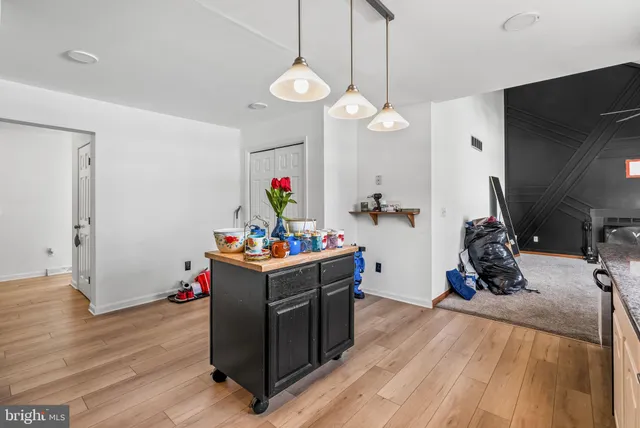 a view of a room with wooden floor and gym equipment