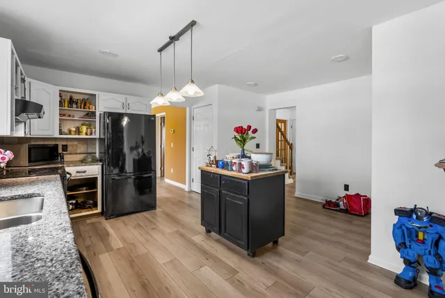 a kitchen with refrigerator and cabinets