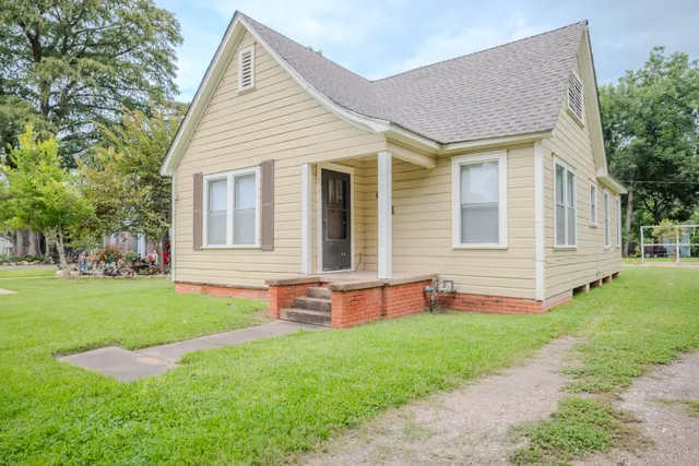 a front view of house with yard and green space