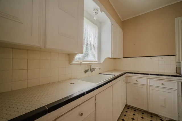 a kitchen with a sink and cabinets