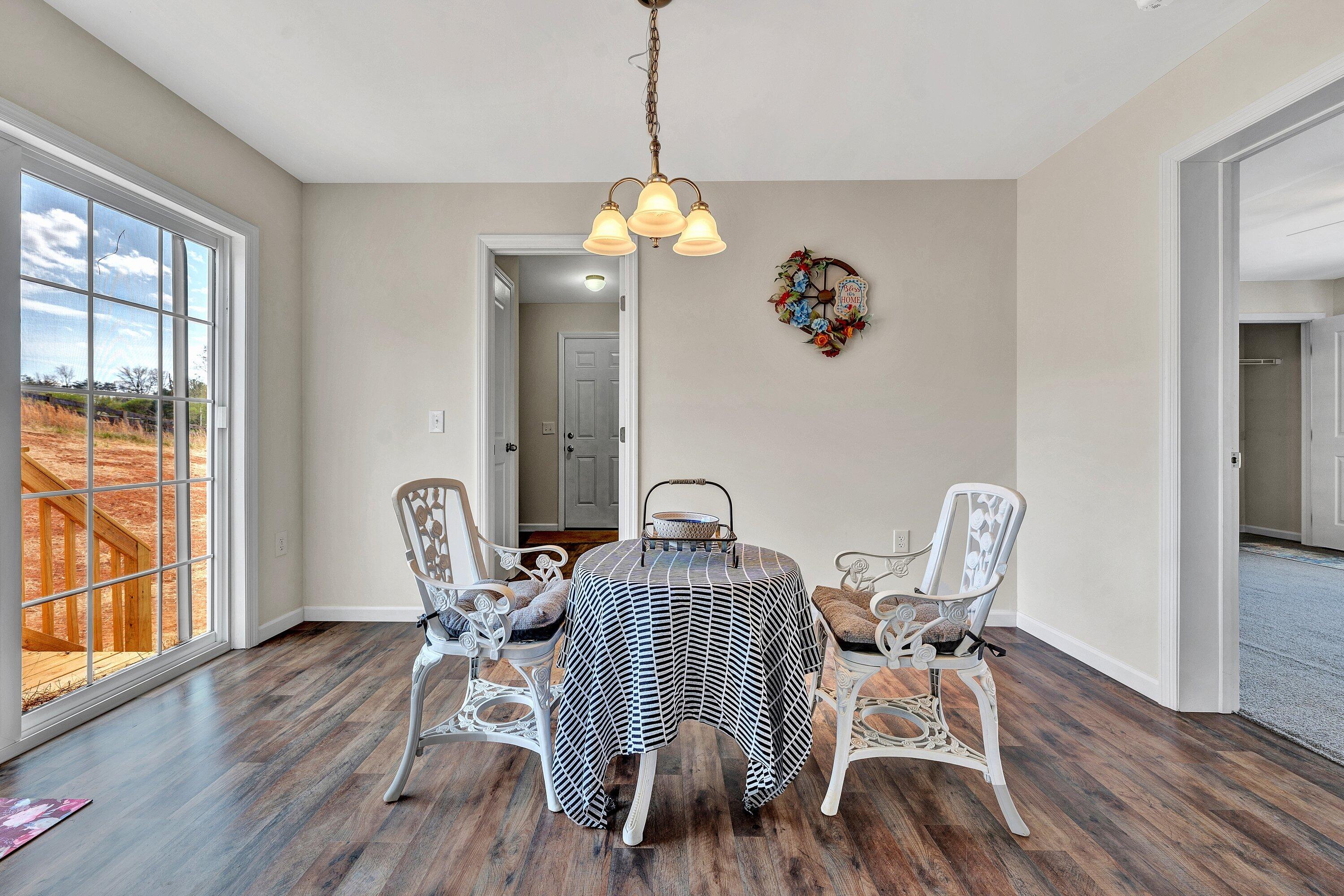6507 Goodview Road Goodview, VA 24095 - Photo 12 of 28 a view of a dining room with furniture window and wooden floor