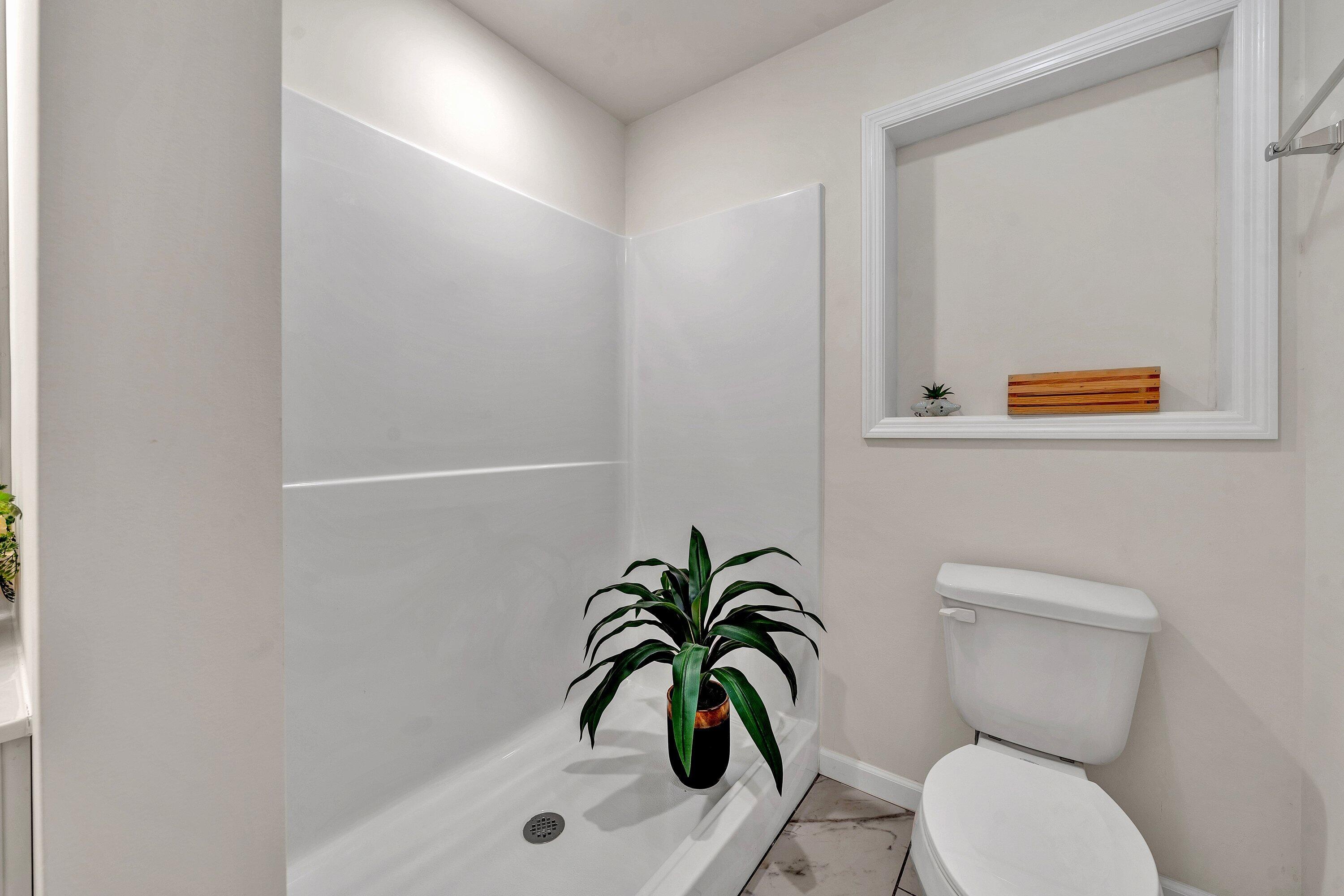 6507 Goodview Road Goodview, VA 24095 - Photo 16 of 28 a bathroom with a toilet and a shower