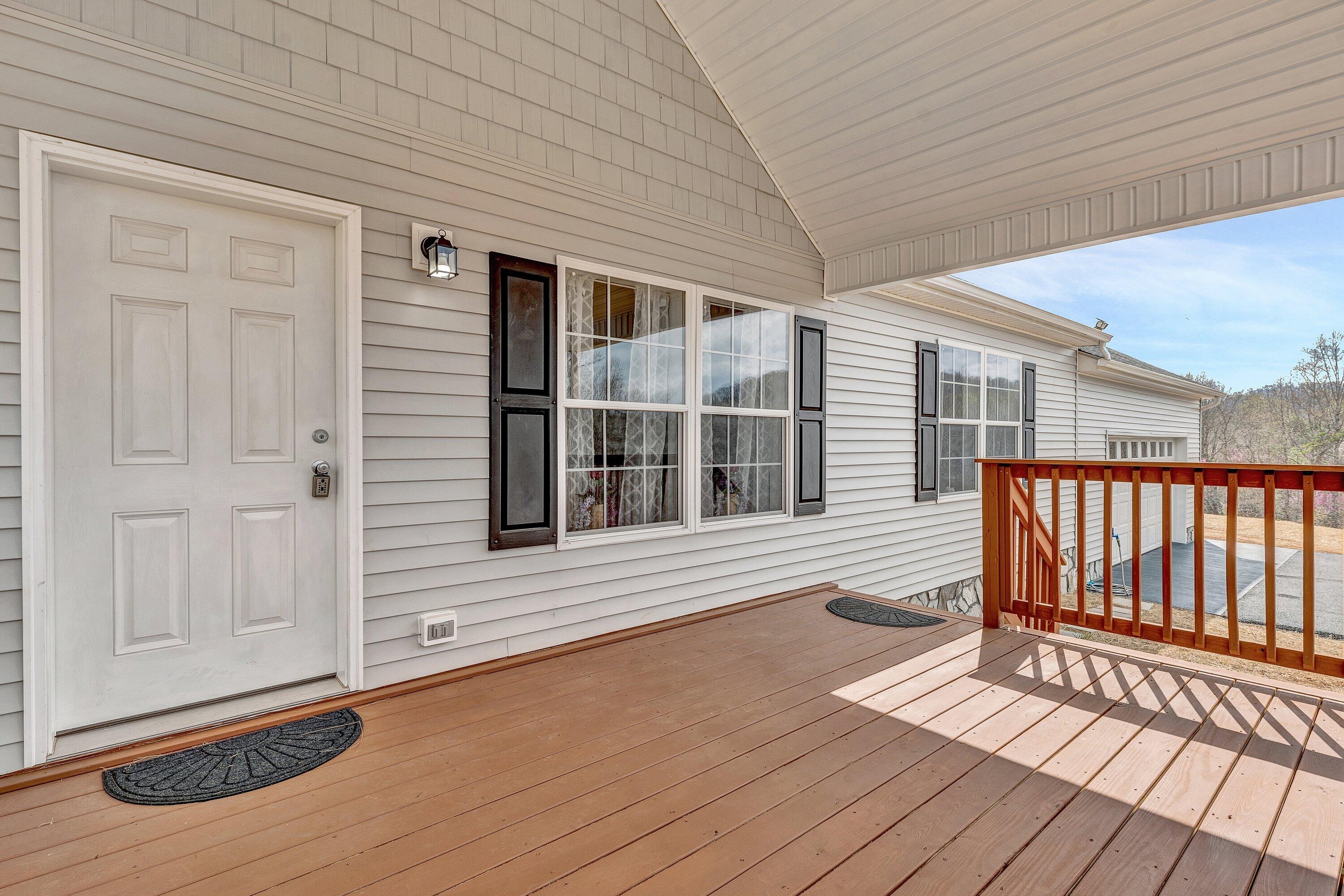 6507 Goodview Road Goodview, VA 24095 - Photo 4 of 28 a view of house with deck outdoor seating and wooden floor