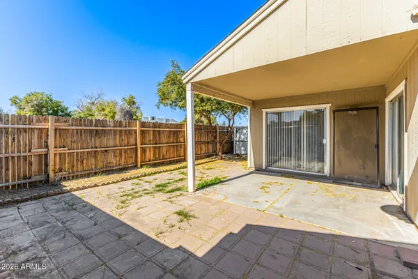 a view of a backyard with sitting area