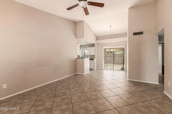 a view of empty room with wooden floor and window