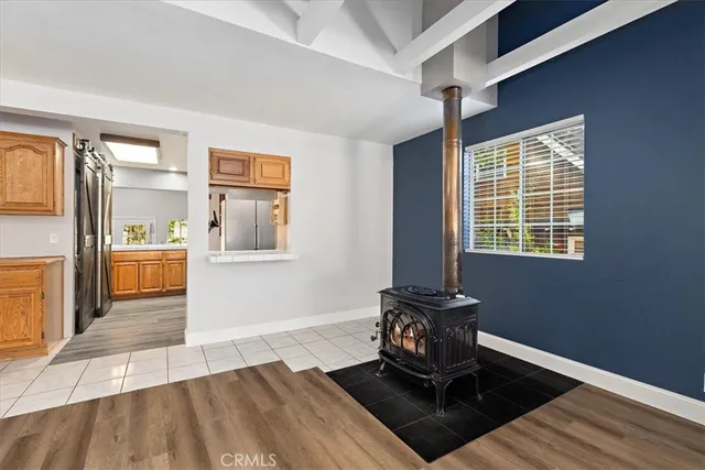a view of a livingroom with wooden floor and a window