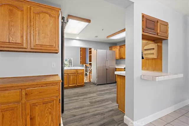 a kitchen with stainless steel appliances granite countertop a refrigerator and a stove top oven