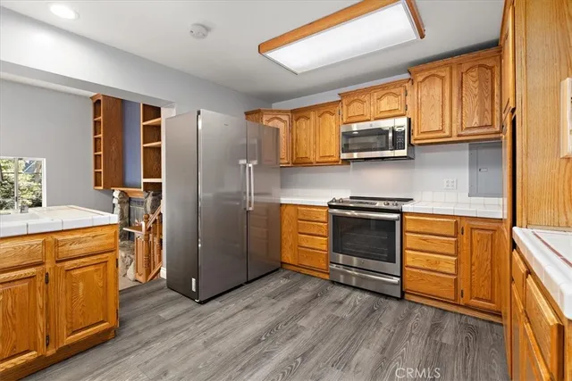 a kitchen with stainless steel appliances a stove a sink and a refrigerator