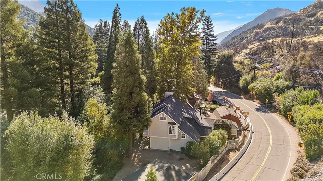 a view of a house with a yard and sitting area