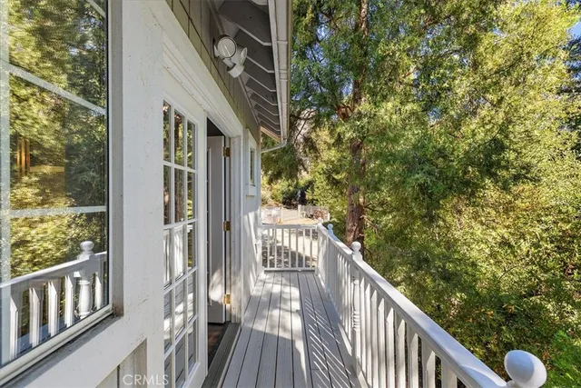 a balcony with wooden floor and fence