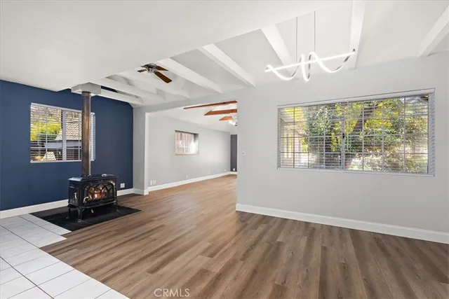 a view of a room with wooden floor and windows