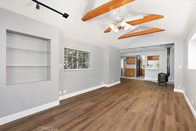 a view of a room with wooden floor and windows