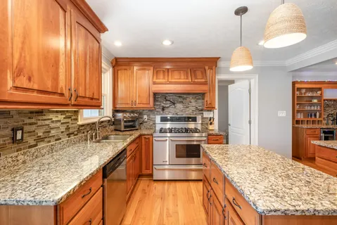 a kitchen with stainless steel appliances granite countertop a stove and a sink