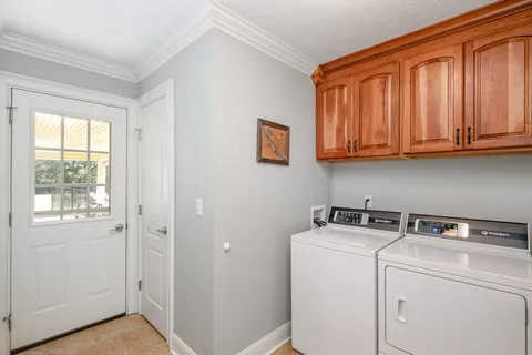 a utility room with closet dryer and washer