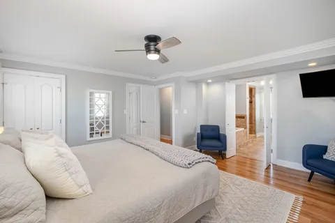 a bedroom with a bed and a television