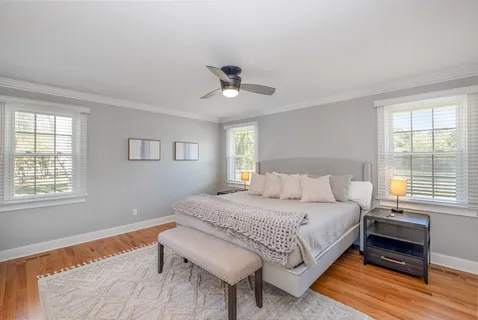 a bedroom with a bed and wooden floor