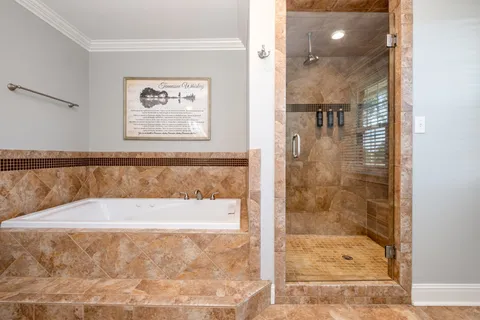 a bathroom with a bathtub and shower