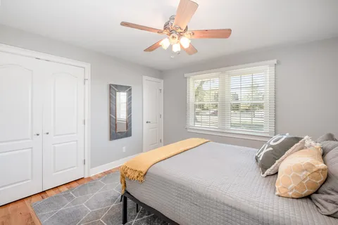 a bedroom with a bed and a chandelier