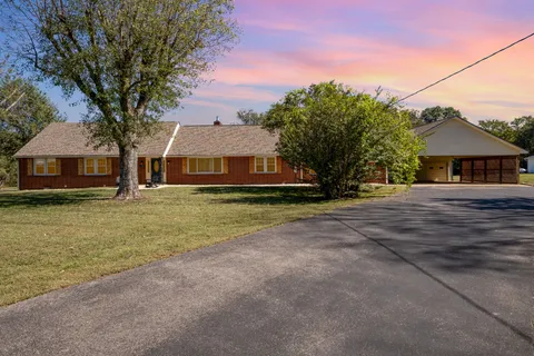 an aerial view of a house with a swimming pool