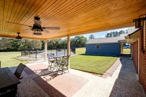 a view of a patio with a table chairs and a patio
